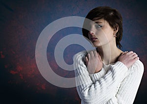 Sad young woman grief against blue background