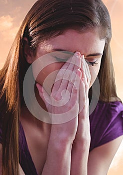 Sad young woman grief holding face against sunset