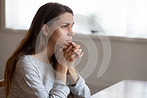 Sad young woman look in distance thinking of problems