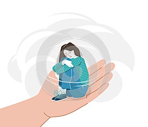 Sad young woman with lowered head hugging herself with her hands on her knees. Anxiety girl sitting on a helping hand