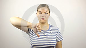 Sad young woman showing thumbs down
