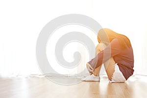 Sad young woman sit in her room and covering