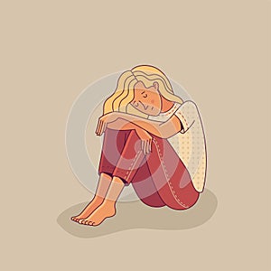Sad young woman sitting alone as illustration of mental disorder