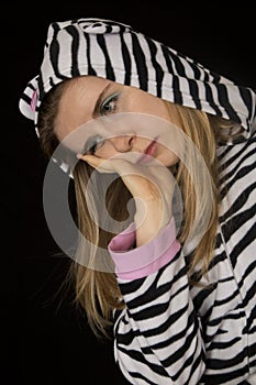 Sad young woman wearing black and white striped cat pajamas