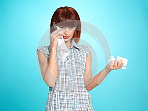 Sad young woman wiping her tears