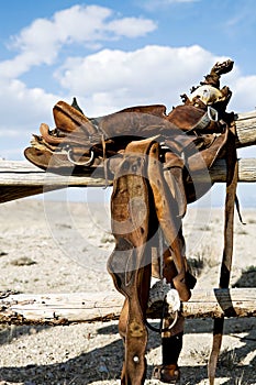 Saddle on rural fence photo