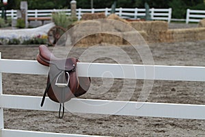 Saddle on a White Fence