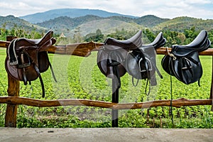 Saddle on wooden fence