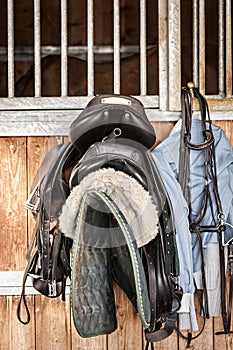 Saddles in front of stable door
