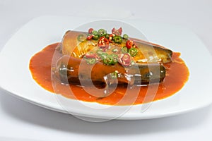 Sadine fish in tomato sauce,chili , lemon juice on white background
