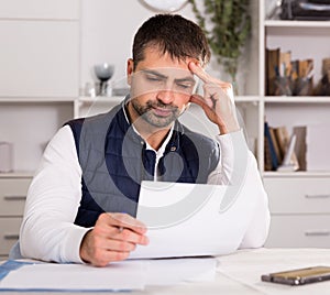 Sadly young man struggling to pay utility bills