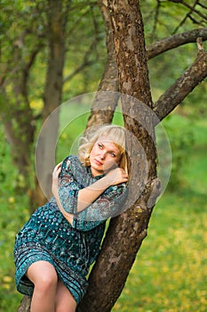 Sadness girl sitting on a tree branch