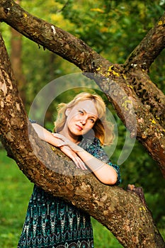 Sadness girl is on a tree branch