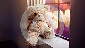 Sadness and Lonelyness Concept. Lonely Teddy Bear Toy Siting Alone beside Window in the Dark Room, City Night Light as Outside Vi