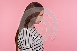 Sadness, negative emotions. Profile of unhappy depressed young woman in striped sweatshirt bowing head