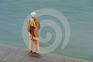 A Sadu ready to pray on the banks of the holy river Ganges in Varanasi, India