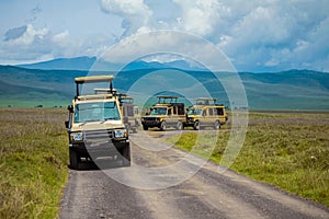 safari jeeps stand on the road in the Ngorongoro National Park in Africa
