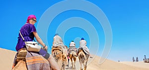 Safari tourism on camels. Sahara desert, Tunisia, North Africa