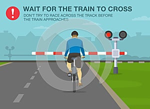 Safe bicycle riding rules and tips. Wait for the train to cross, don`t try to race across the track before the train approaches. photo