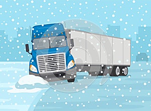 Front view of a truck skidded across the icy road. Blue semi-truck loses control and gets stuck at the edge of the road.