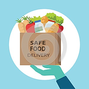 Safe food delivery at home during coronavirus covid-19 epidemic: delivery man hand  holding a bag with fast food,he is wearing a