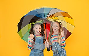 Safe place. Fashion accessory. Girls friends with umbrella. Rainy day. Happy childhood. School time. Rainbow umbrella