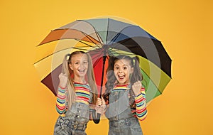 Safe place. Fashion accessory. Girls friends with umbrella. Rainy day. Happy childhood. School time. Rainbow umbrella