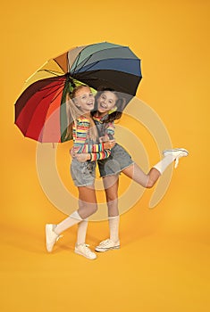 Safe place. Schoolgirls happy umbrella. Fall weather forecast. Safety concept. Fashion accessory. Girls friends with