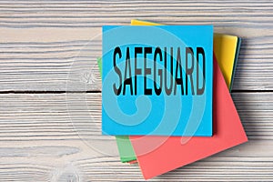 SAFEGUARD - word on note paper on wooden light background