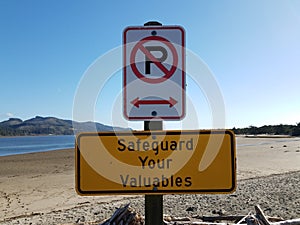 safeguard yoru valuables and no parking sign on beach