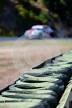 Safety barrier with rubber tires aligned in a row on asphalt motorsport circuit
