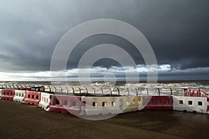 Safety barriers at the sea front as a storm approaches