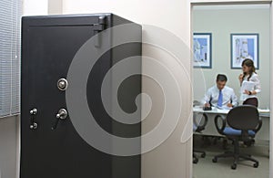 Safety box in an office with an employee and his secretary