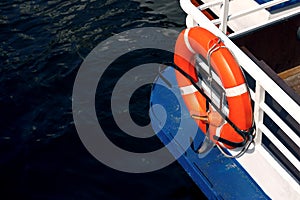 Safety concept: Red life buoy on the boat ready for use