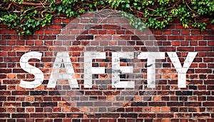 SAFETY on dark texture of old red bricks wall