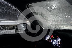 Safety driving. Car stopped on roadside in snowfall due to frozen windshield