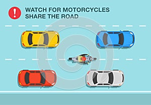 Safety driving rule. Watch for motorcycles, share the road. Motorcycle rider between cars on the road.