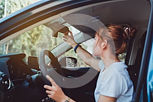 Safety driving woman adjust the car rearview mirror