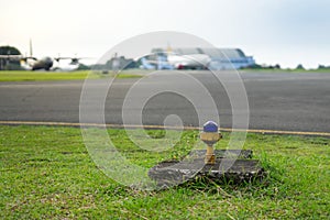 Safety Edge Blue Light Beside Airport Taxiway with Blur Airplane on Background