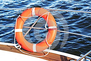 Safety equipment on a boat, life buoy or rescue buoy floating on sea.