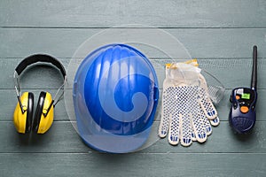 Safety equipment with radio transmitter on wooden background