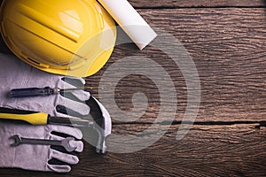 Safety equipment and tool kit on wooden background