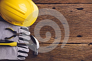 Safety equipment and tool kit on wooden background