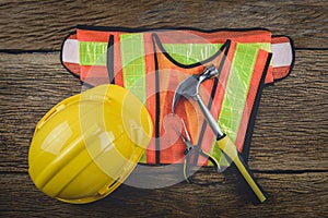 Safety equipment and tool kit on wooden background