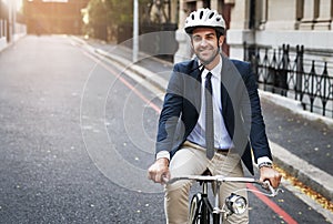 Safety first. Shot of a handsome young businessman riding his bicycle to work in the morning.