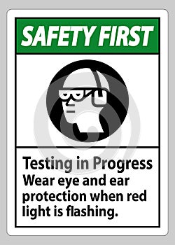 Safety First Sign Testing In Progress, Wear Eye And Ear Protection When Red Light Is Flashing