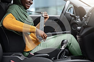 Safety First. Unrecognizable Black Muslim Lady Fasten Seatbelt Before Car Ride
