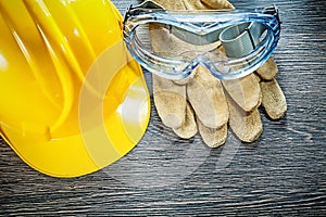 Safety goggles hard hat on wooden board