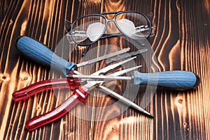 Safety googles, eyeglasses with pliers, screwdrivers, saw blades