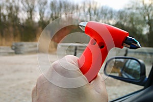 Safety hammer being used to smash window glass